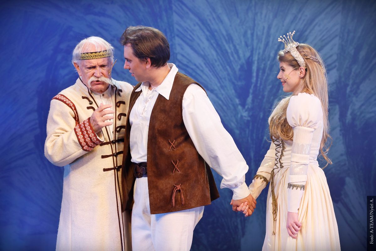 A színművészek a Holdbeli csónakos című darabban párbeszédet folytatnak a színpadon.